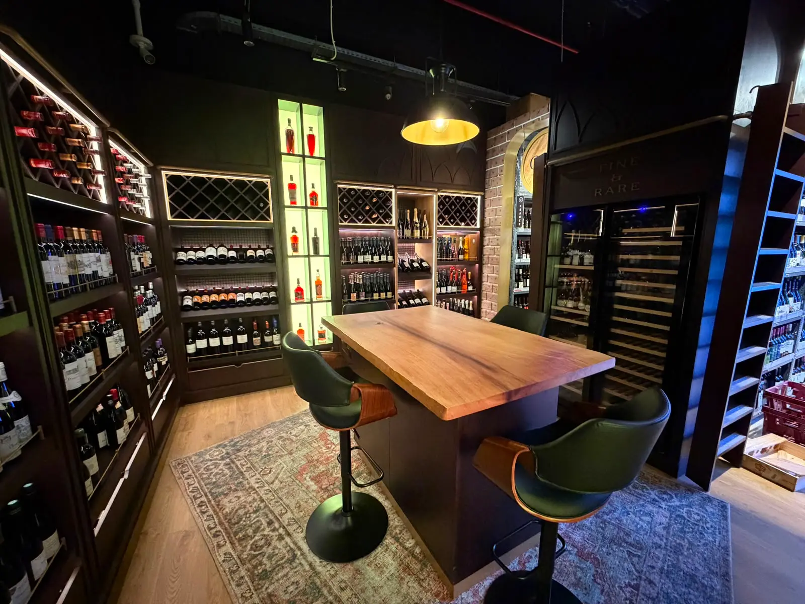 The CRU consultation table, set beneath warm lighting between fine wine shelving.
