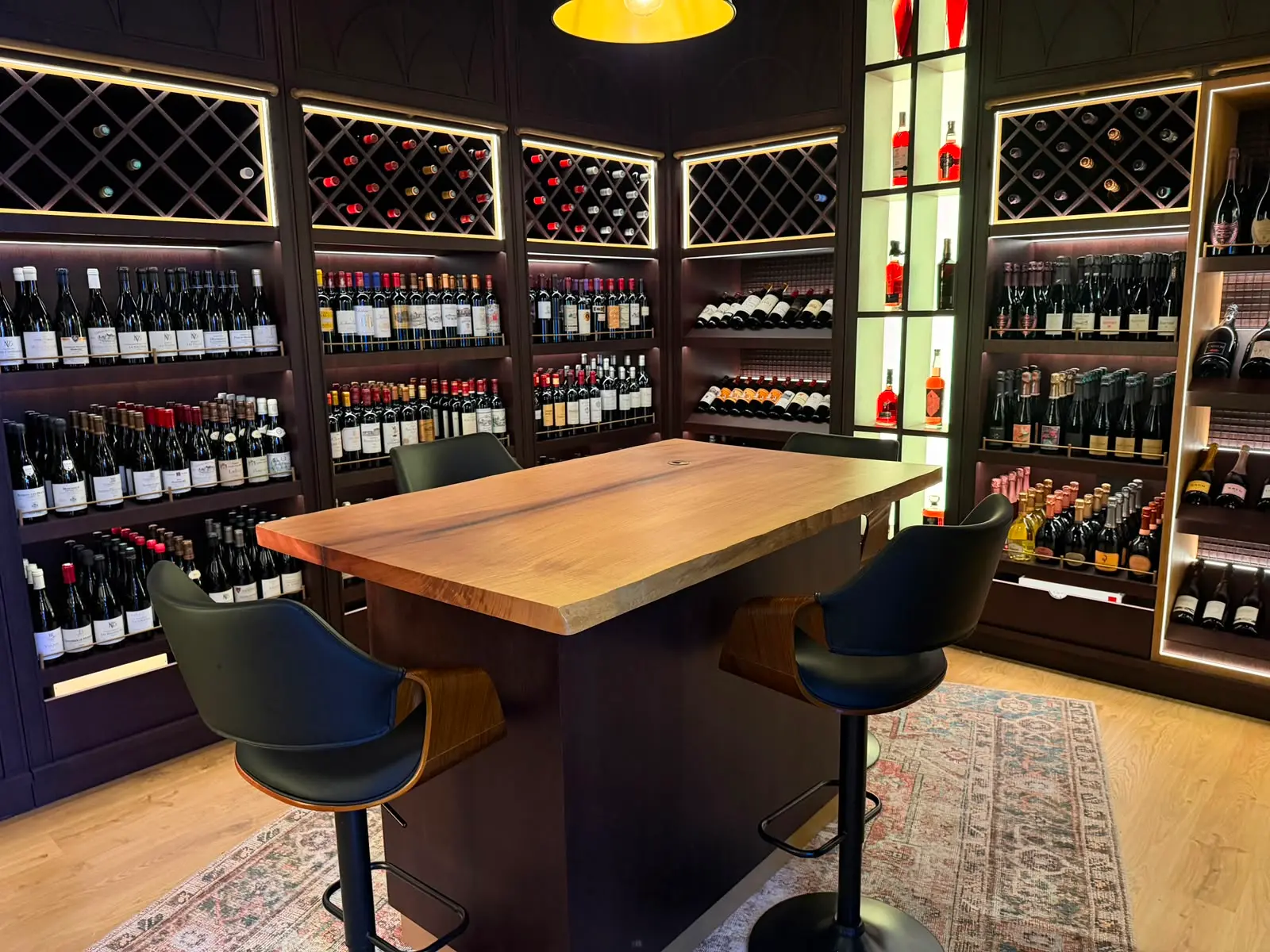 Luxury spirits display, backlit against dark timber.